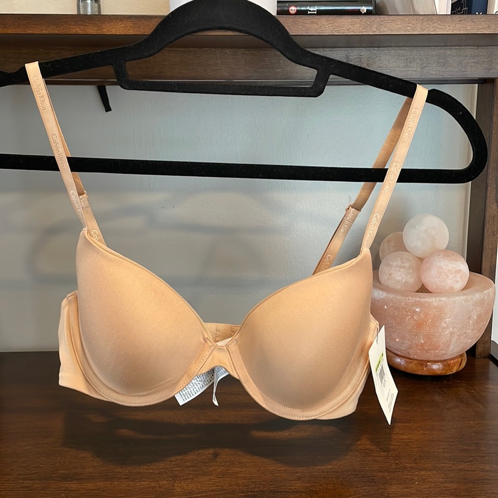 New with tags - Calvin Klein lightly lined Demi bra, 34B, in nude.
